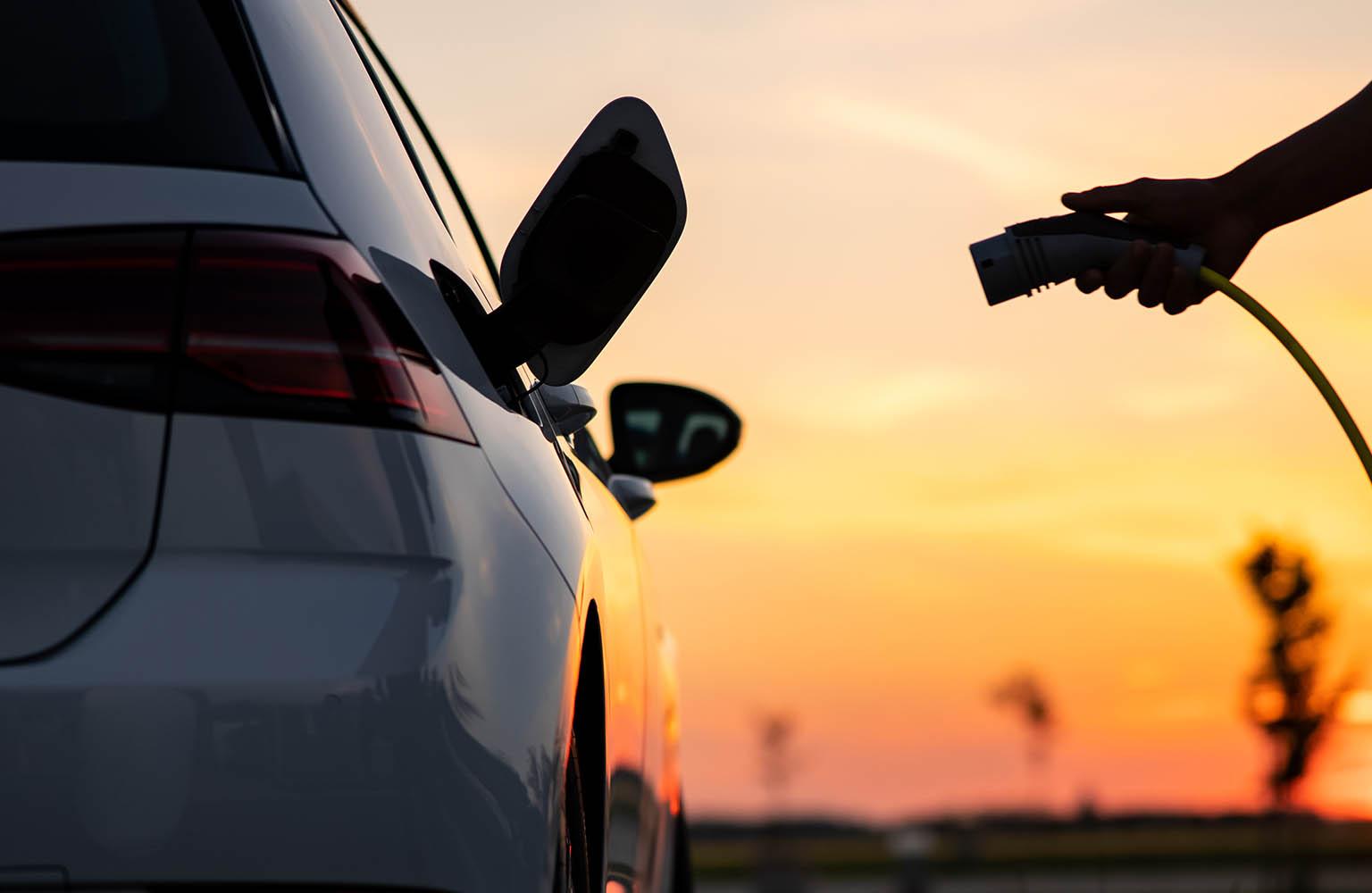 Ladekabel wird in den Tankanschluss eines Elektroautos gesteckt.