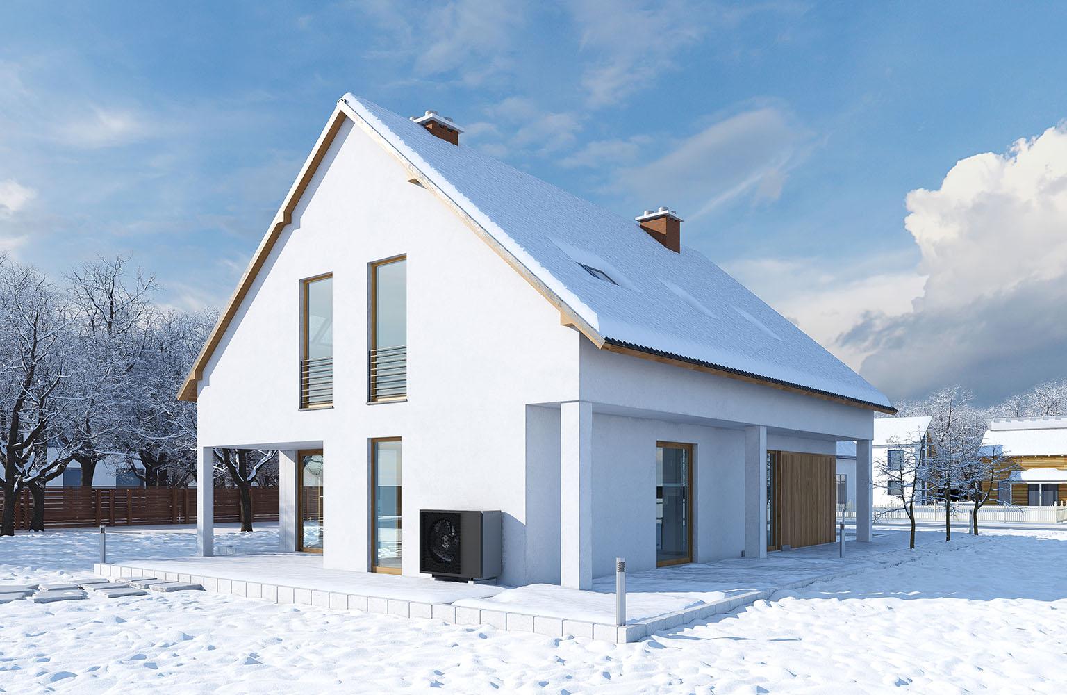 Haus mit Wärmepumpe in Schneelandschaft